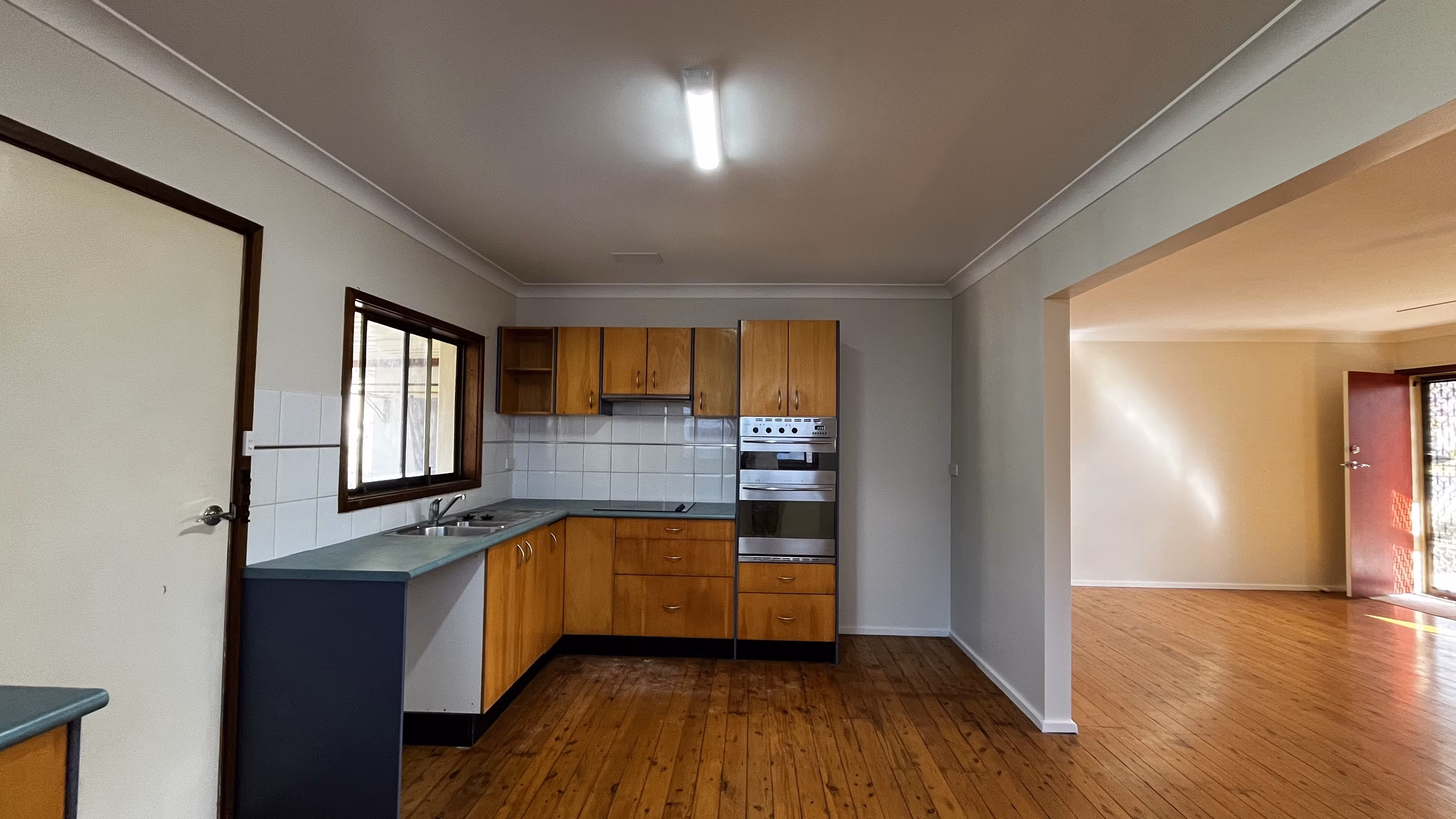 Kitchen and living area after nicotine-damage cleaning, sealing and repainting