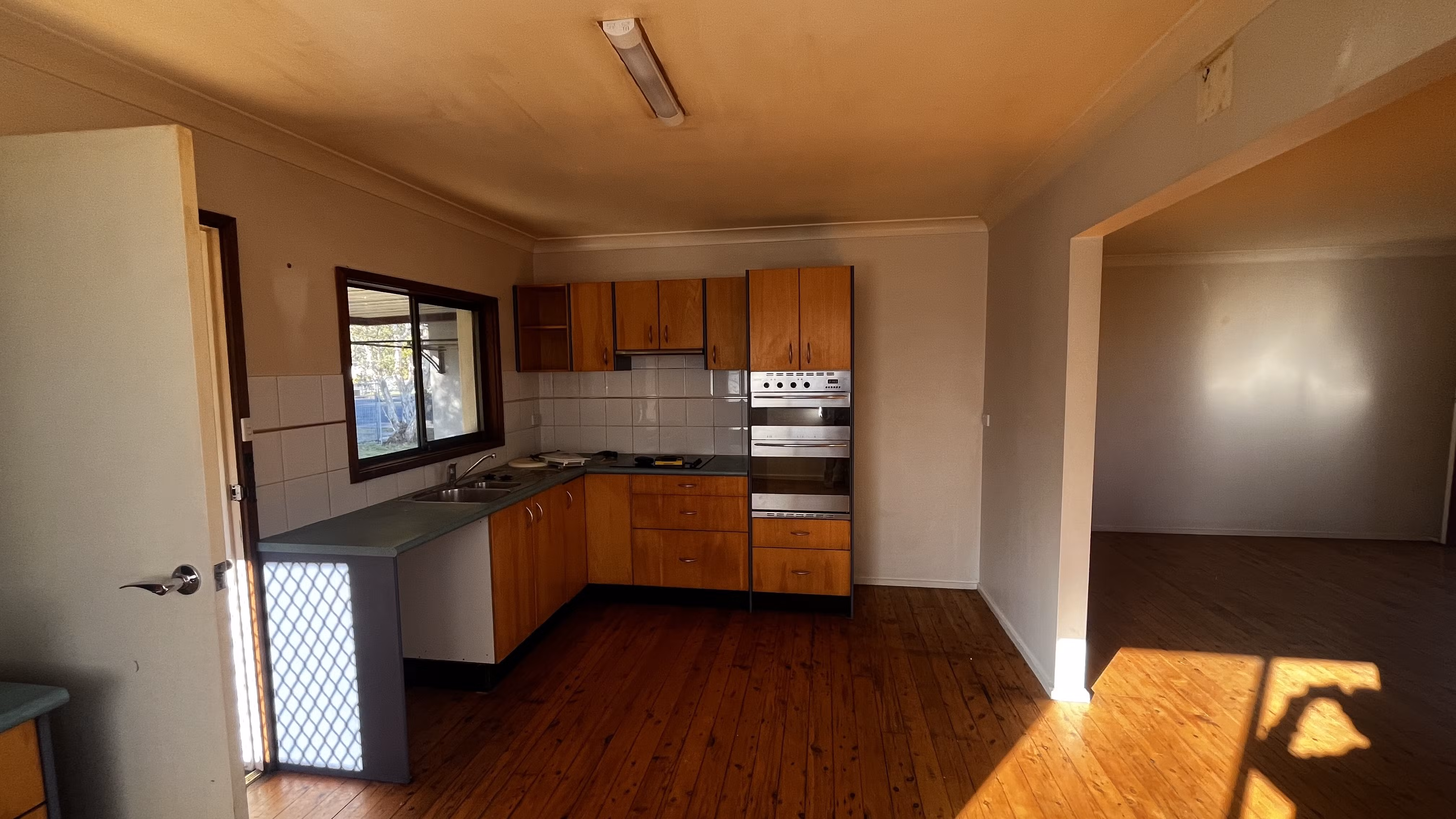Kitchen and living area with nicotine-stained walls and ceiling before repainting
