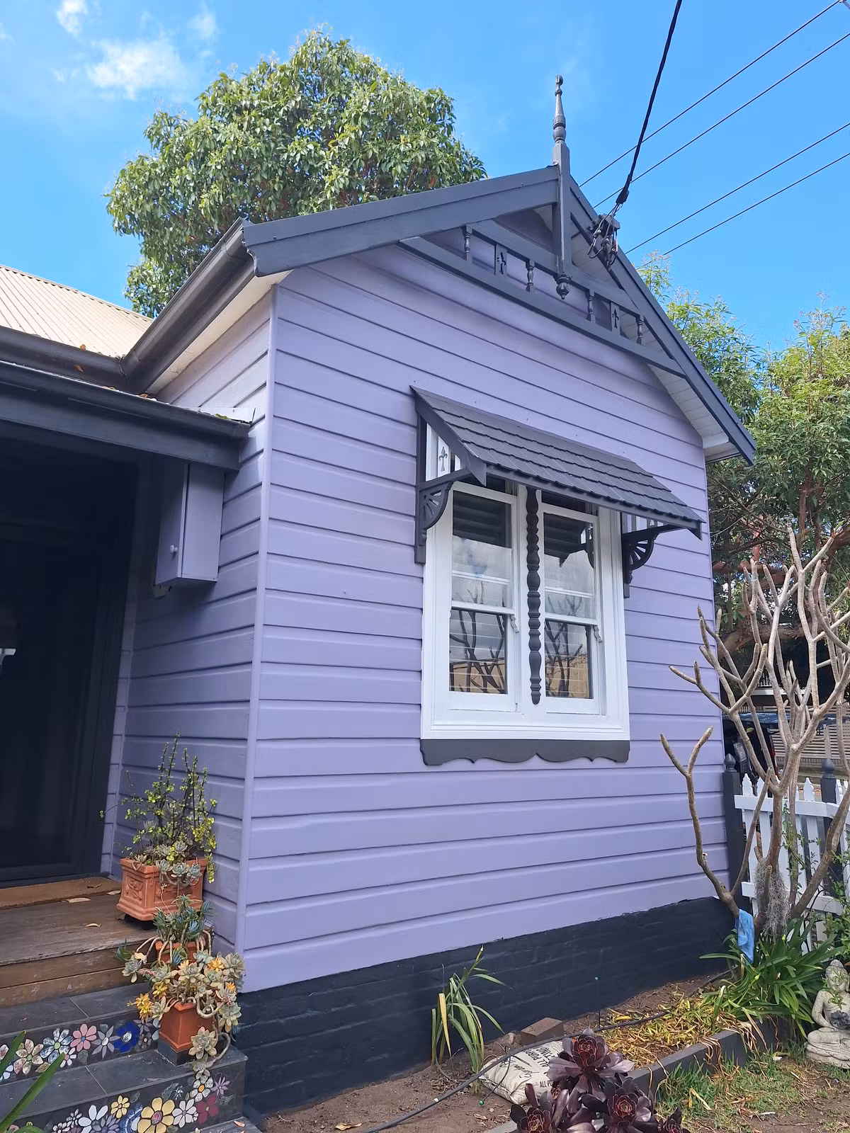 Completed weatherboard facade repaint in Maryville with purple weatherboards and dark trim