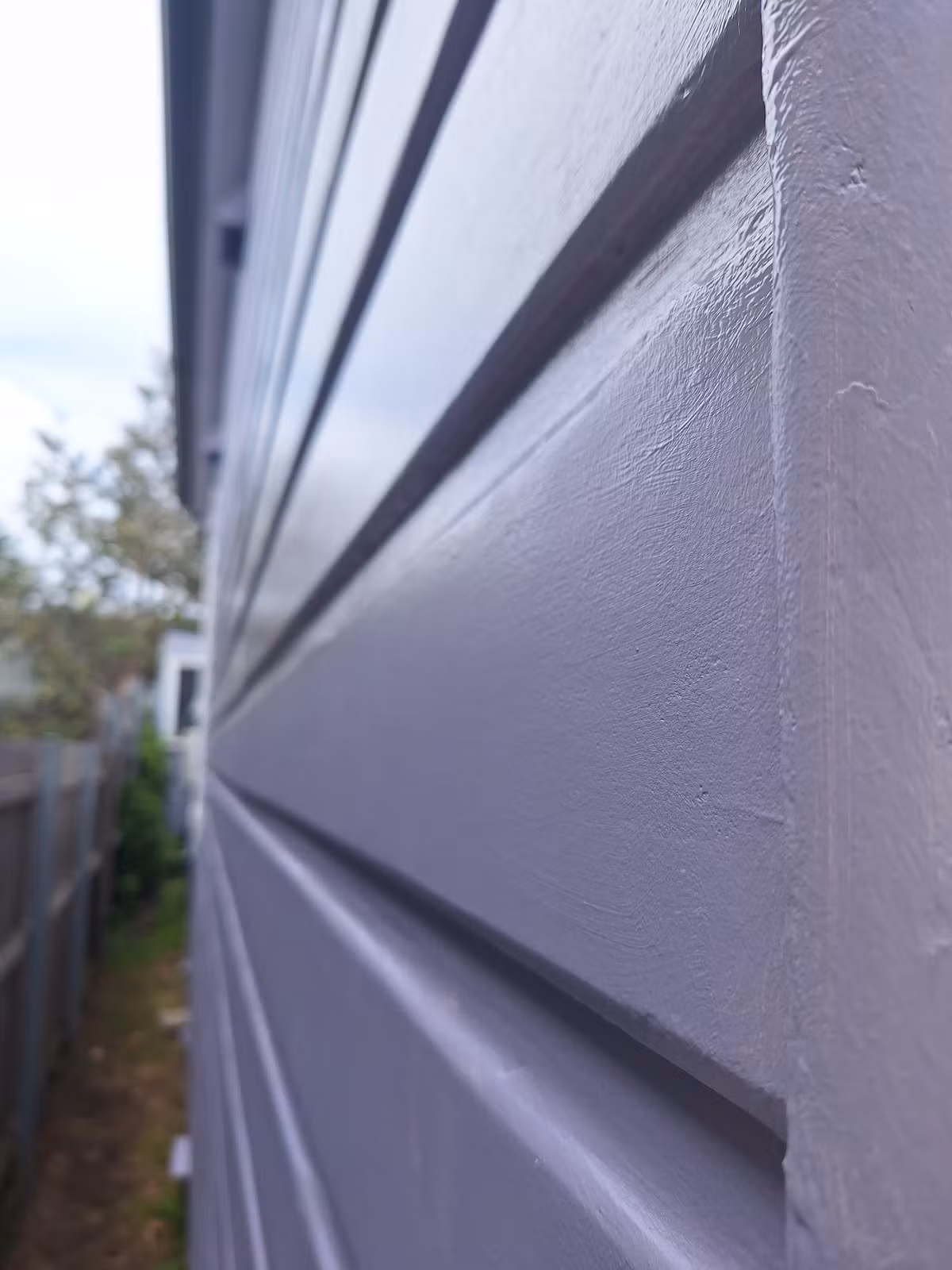 Close-up of the finished weatherboards showing the retained timber texture