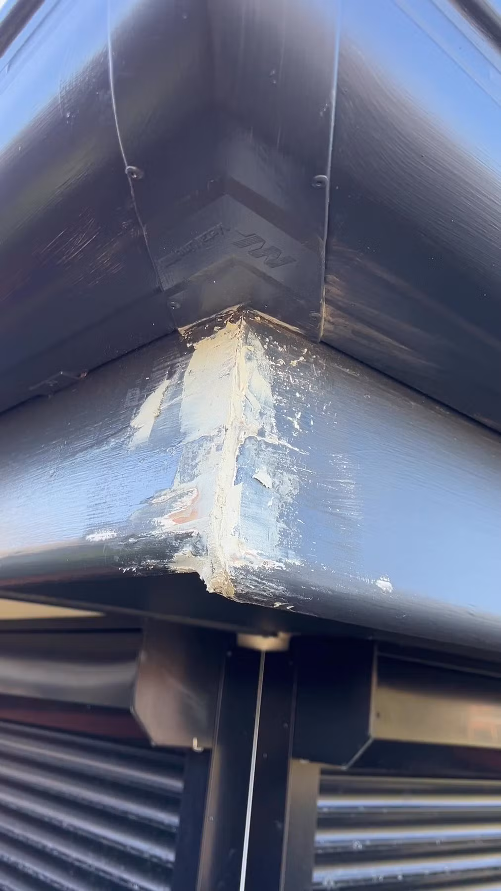 Failed coating on an exterior corner before scraping and preparation