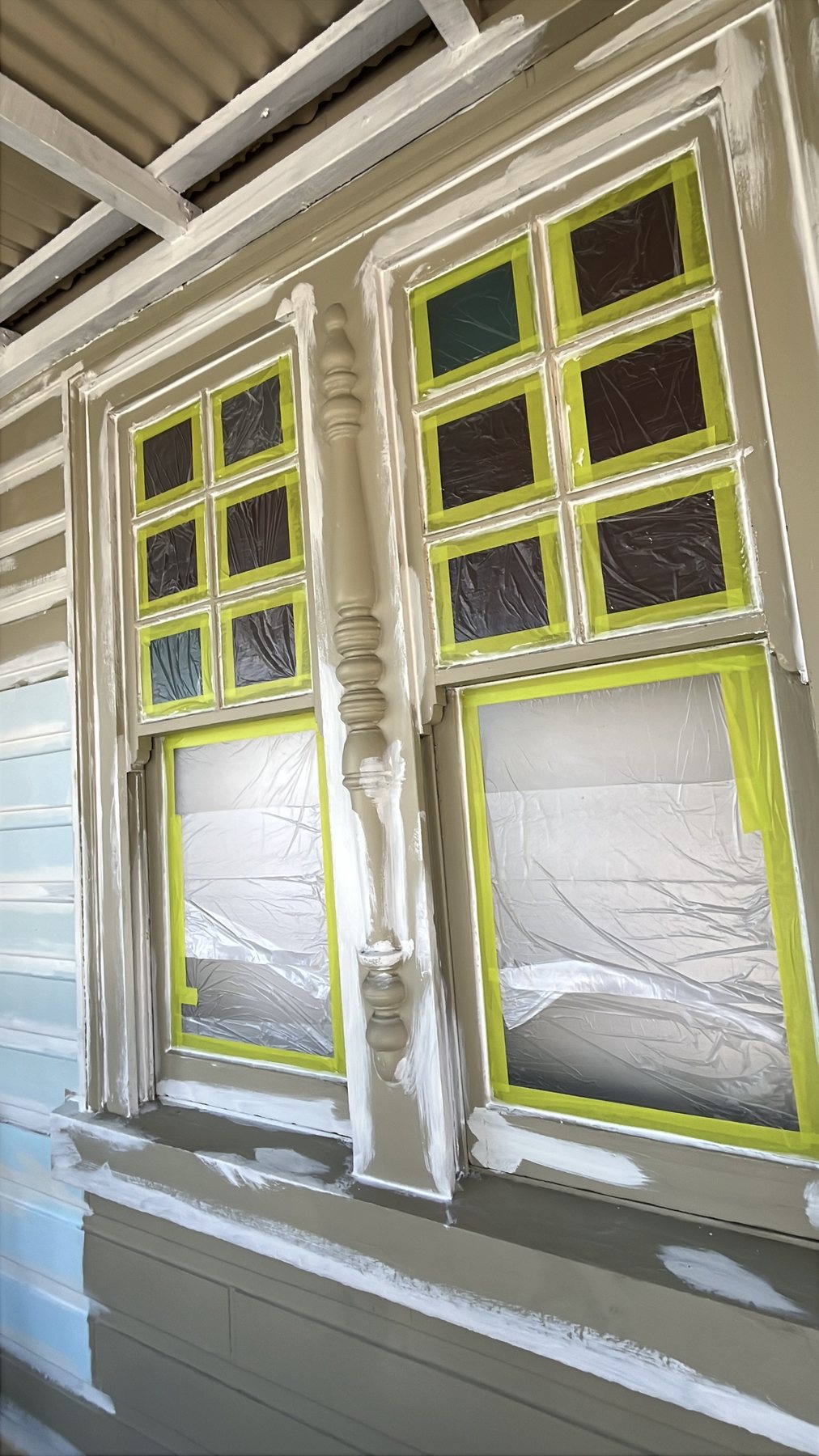 Window carefully masked during exterior house preparation