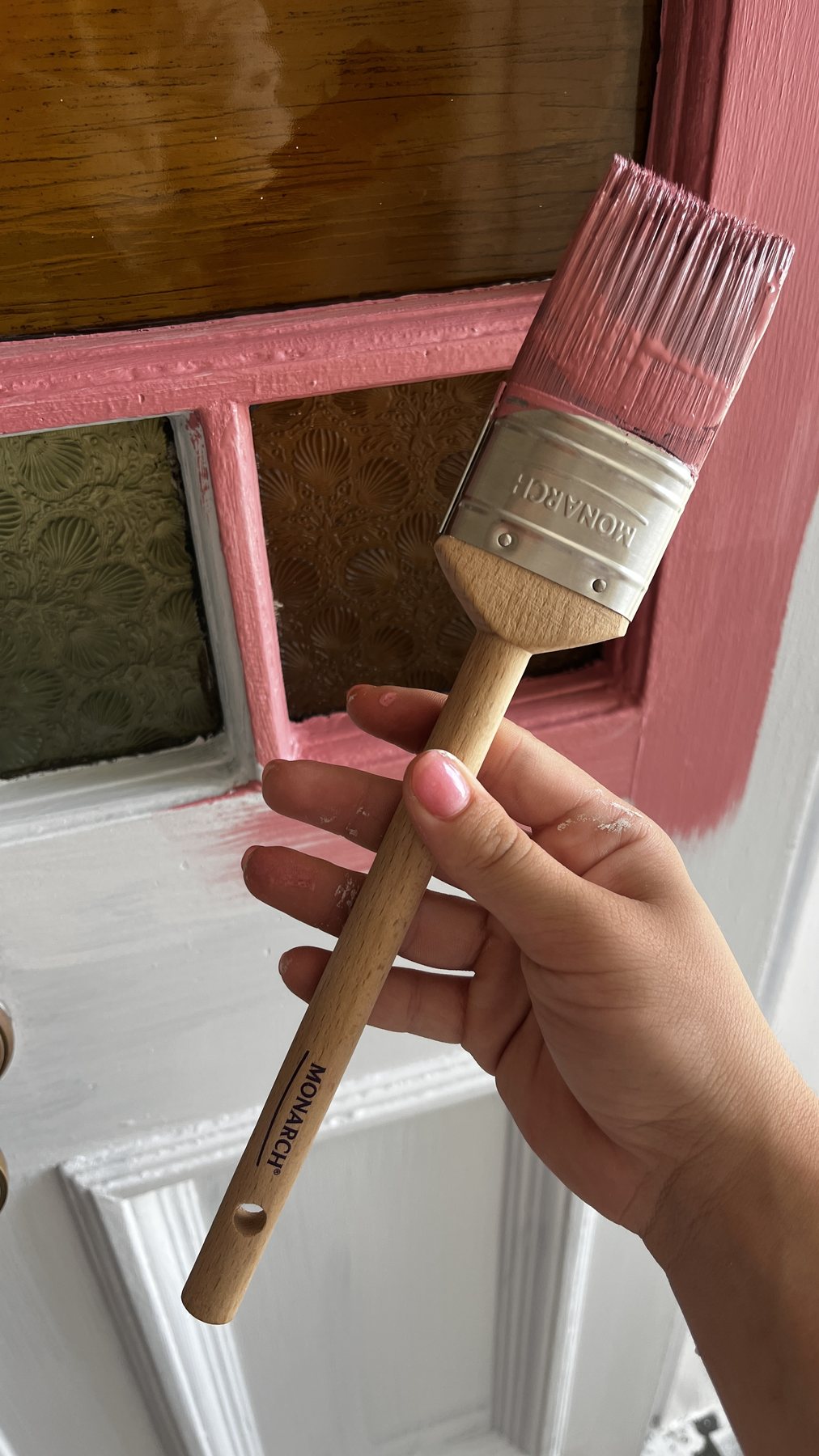 Brush painting the timber front door in Porter's Rosewood